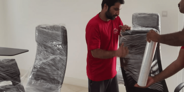 Furniture Movers Dubai | Heavy Item Handling Furniture movers Dubai transporting sectional sofa down staircase
